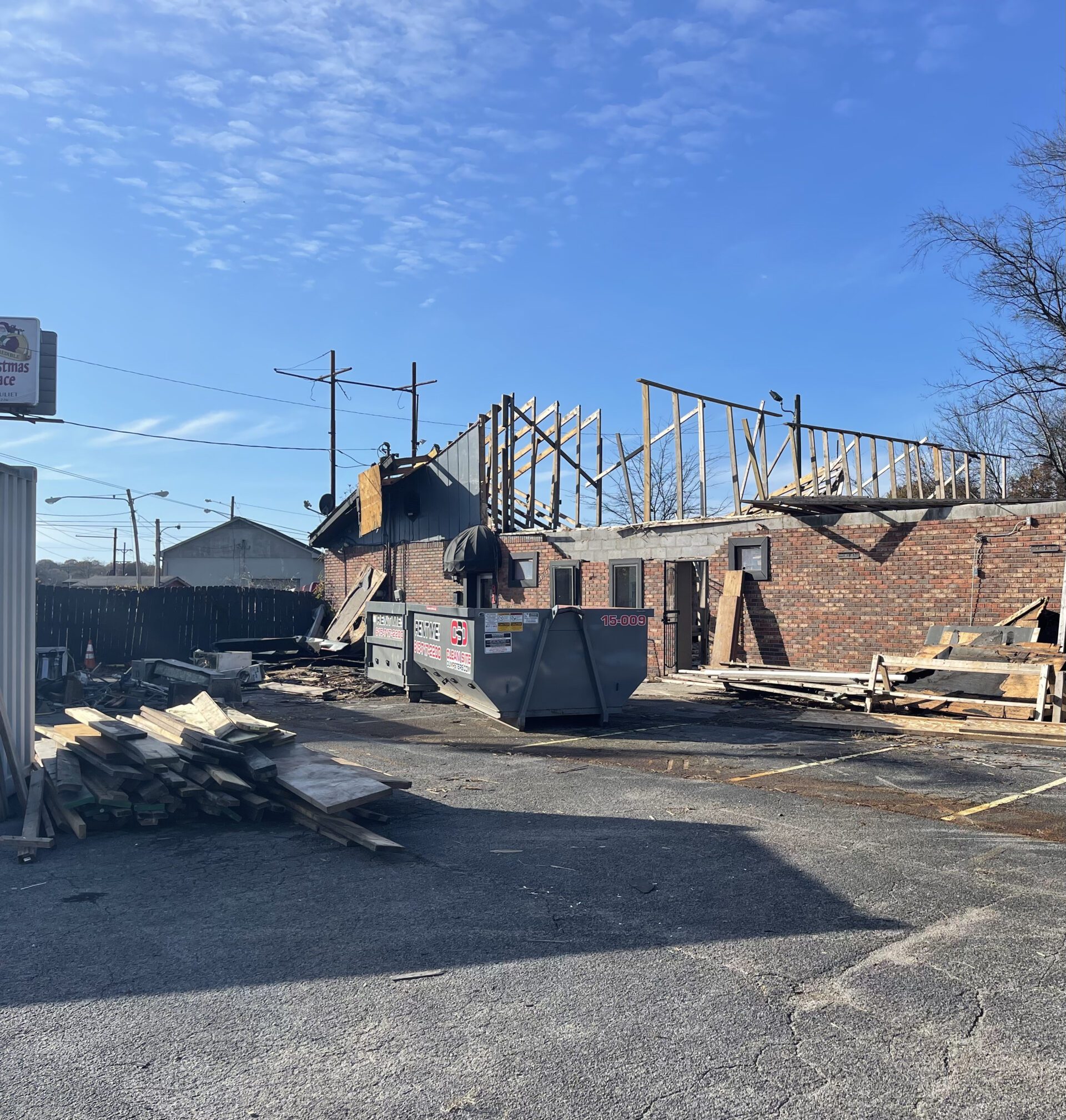 Construction debris being loaded into dumpster